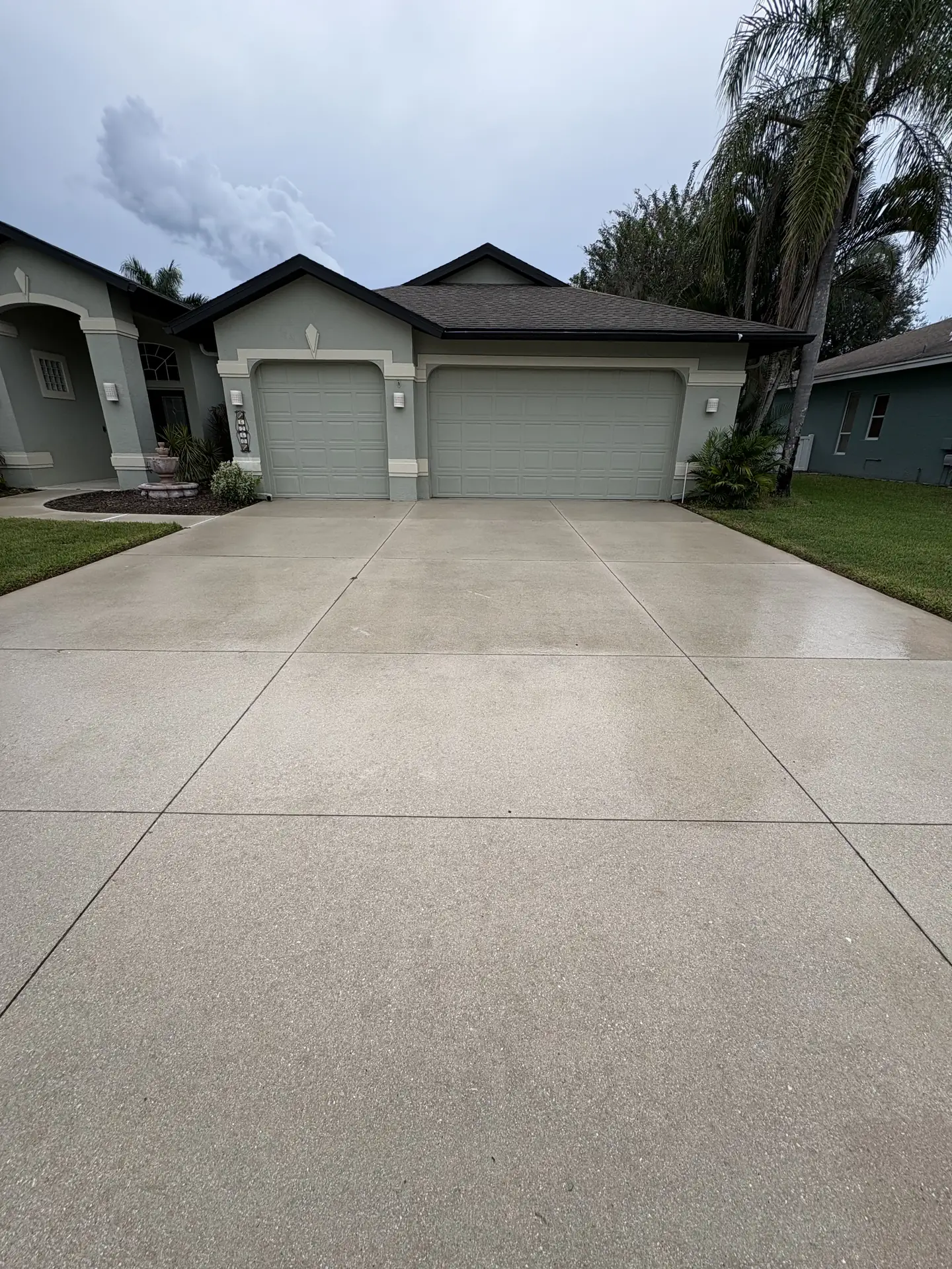 The same driveway and garage, the concrete clean and light